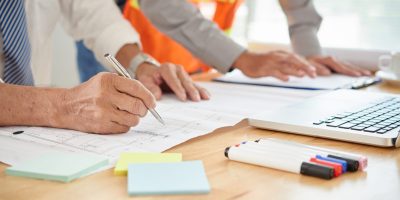 Close-up image of engineer making marks on blueprint